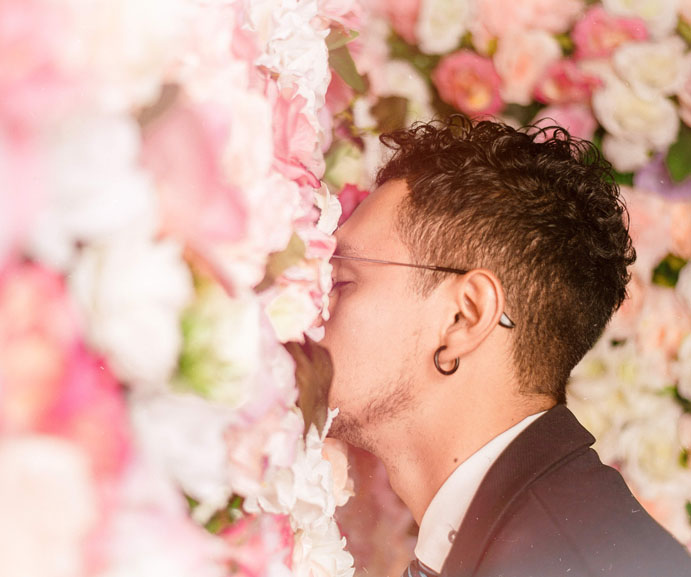 Man smelling flowers