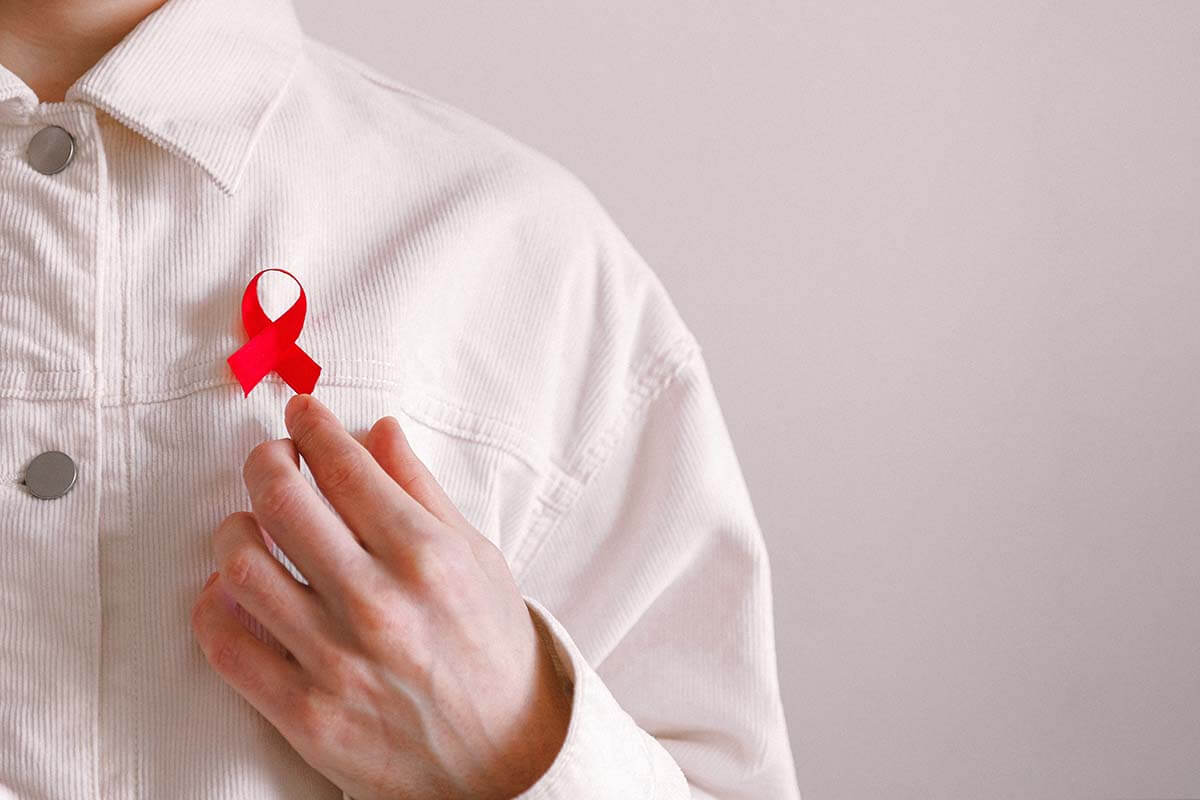 Red HIV ribbon pinned to shirt