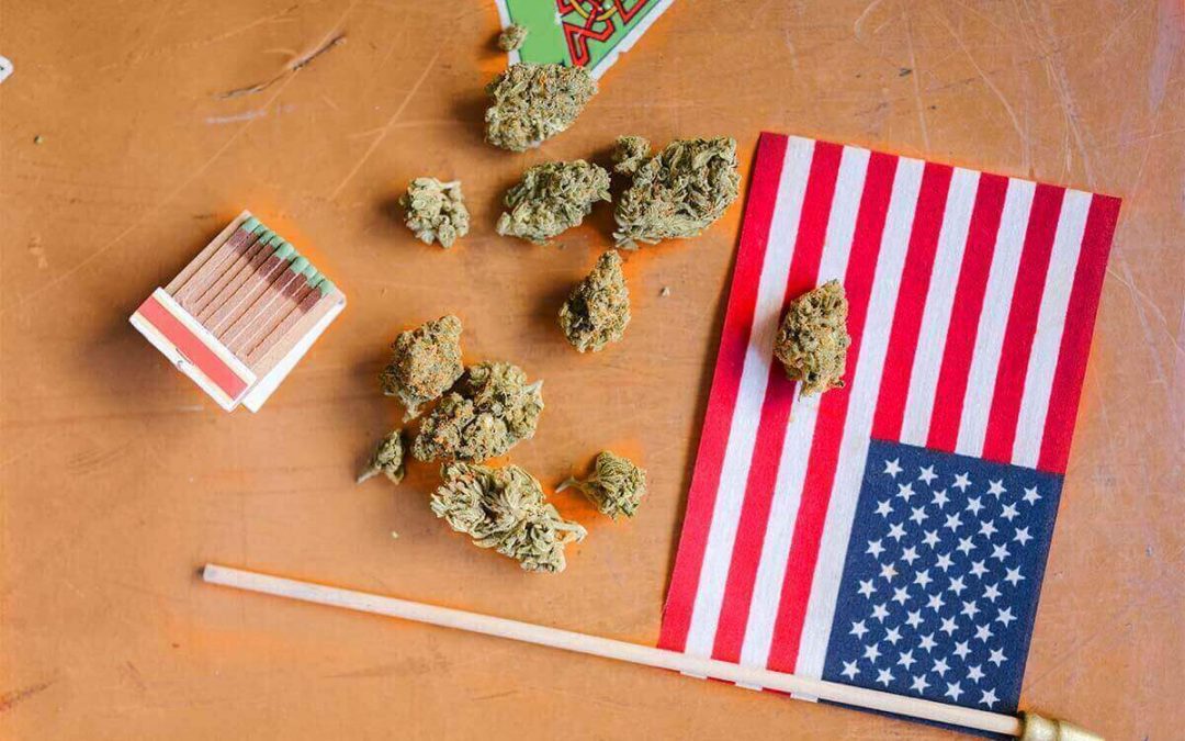 dried marijuana and an American flag on a wooden table