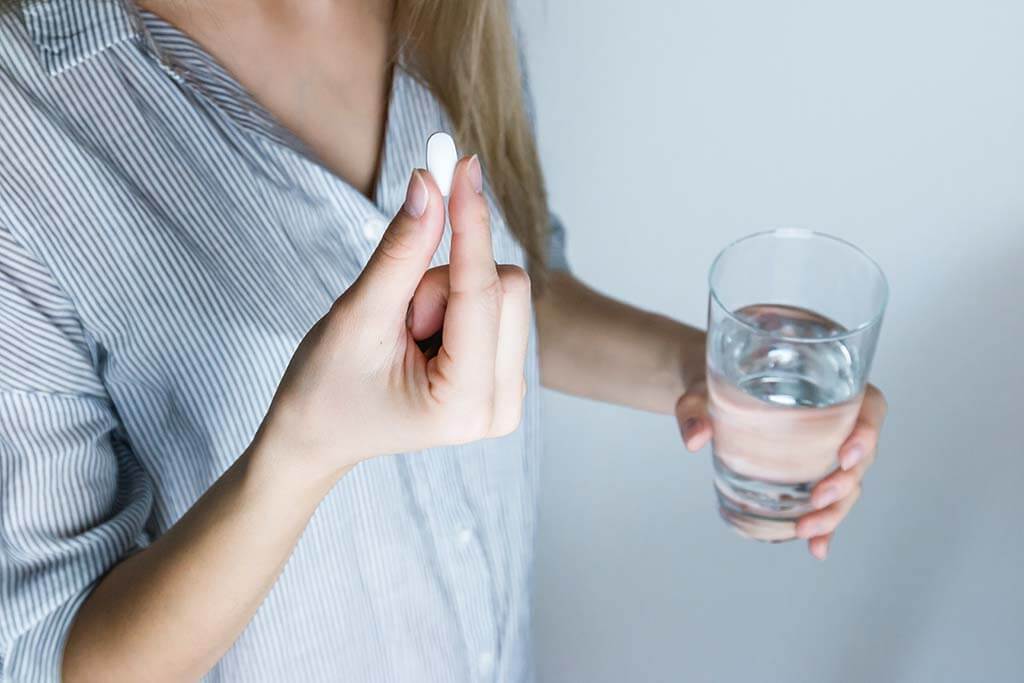 Patient taking a Zoloft pill for her anxiety and depression