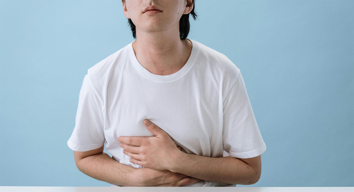 marijuana-for-nausea Patient holding their upper stomach because they feel nauseous